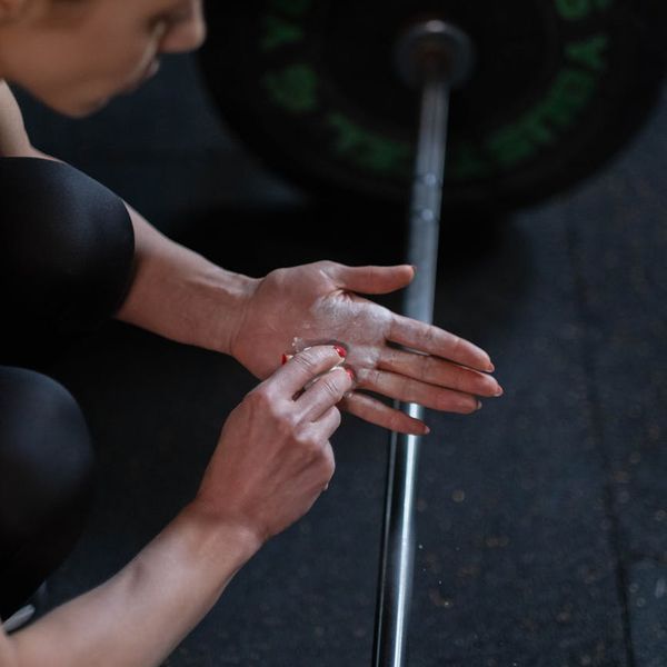 Close up of a hand gripping a barbell handle