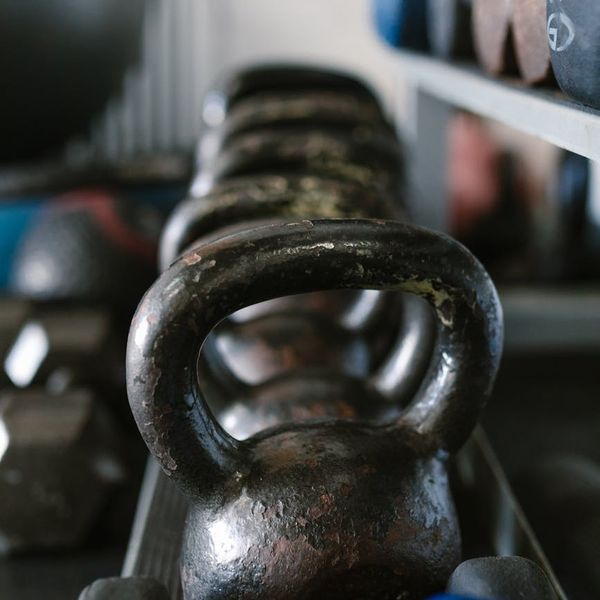 Kettlebell and weights on a gym floor with neon light